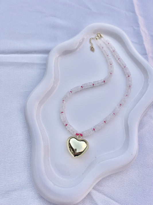 Necklace with a heart-shaped pendant on a white dish