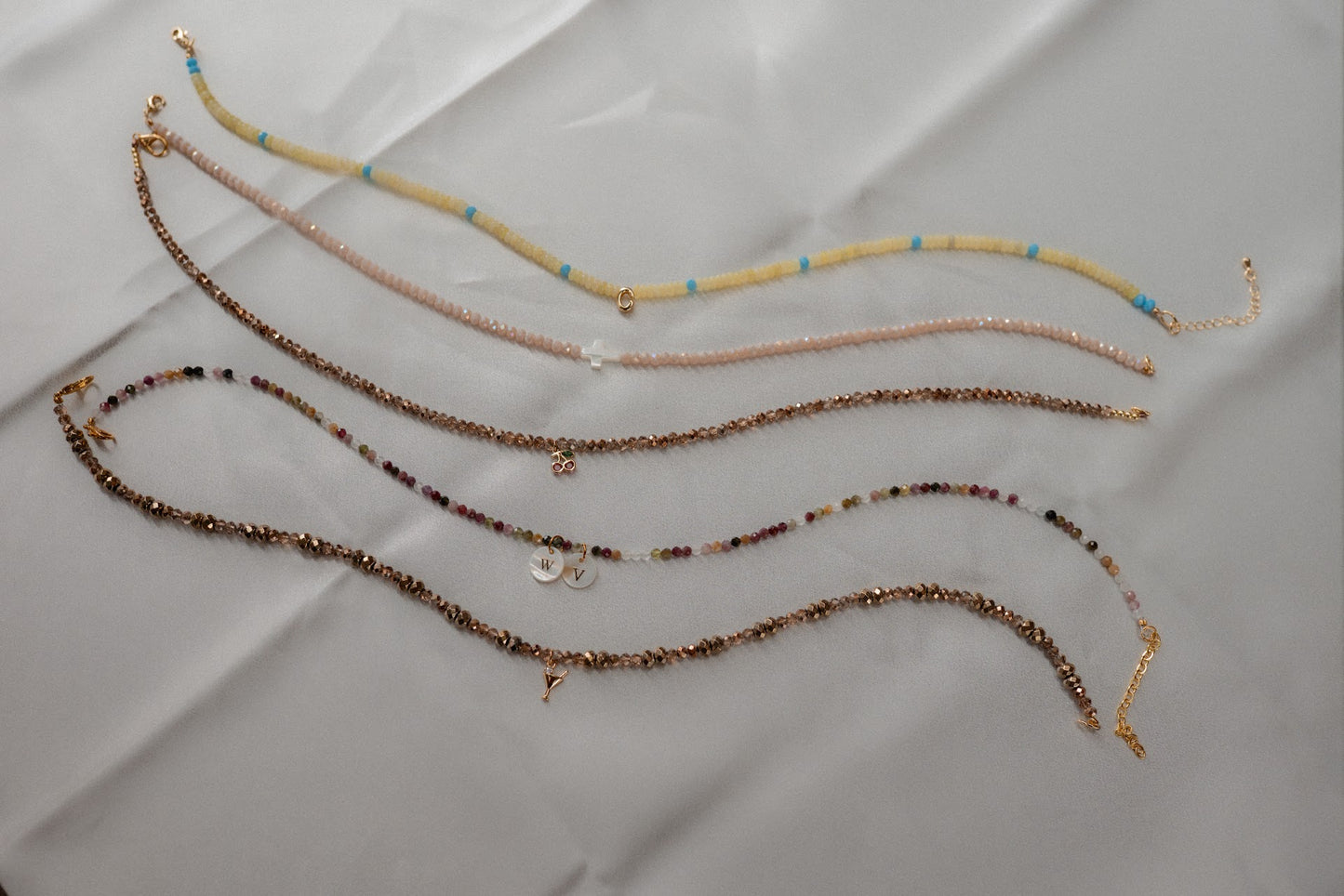 Set of beaded necklaces on a light gray surface