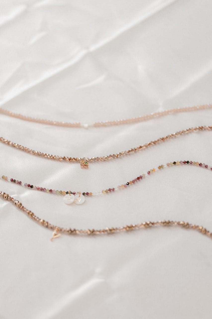 Set of three delicate necklaces on a light background