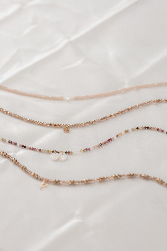 Set of three delicate necklaces on a light background